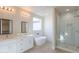 Modern bathroom with soaking tub, double vanity, and glass shower at 57968 W Fulcar Rd, Maricopa, AZ 85139