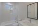 Modern bathroom with white tile, bathtub and quartz countertop at 57968 W Fulcar Rd, Maricopa, AZ 85139