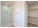 Clean bathroom with a glass shower and closet at 57968 W Fulcar Rd, Maricopa, AZ 85139