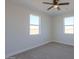 Well-lit bedroom with two windows and carpet at 57968 W Fulcar Rd, Maricopa, AZ 85139