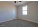 Bright bedroom featuring carpet flooring and a large window at 57968 W Fulcar Rd, Maricopa, AZ 85139