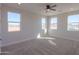 Bright bedroom with multiple windows and carpeted floor at 57968 W Fulcar Rd, Maricopa, AZ 85139