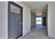 Modern entryway with grey door and view to backyard at 57968 W Fulcar Rd, Maricopa, AZ 85139