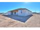 Rear view of house showcasing patio and desert landscape at 57968 W Fulcar Rd, Maricopa, AZ 85139