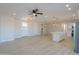 Open floor plan living area with luxury vinyl plank flooring and kitchen island at 57968 W Fulcar Rd, Maricopa, AZ 85139