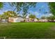 Spacious backyard with a large lawn and partial view of the pool at 5801 E Exeter Blvd, Phoenix, AZ 85018