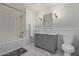 Elegant bathroom with a gray vanity, marble countertop, and tiled shower at 5801 E Exeter Blvd, Phoenix, AZ 85018