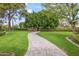 Landscaped side yard with a brick pathway and lush greenery at 5801 E Exeter Blvd, Phoenix, AZ 85018