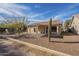 Covered patio, gravel yard, cactus, and mature trees at 6307 S Palo Blanco Dr, Gold Canyon, AZ 85118