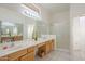 Bathroom with double sinks, wood cabinets and shower at 6307 S Palo Blanco Dr, Gold Canyon, AZ 85118