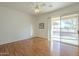 Bright bedroom with wood floors and sliding glass door to patio at 6307 S Palo Blanco Dr, Gold Canyon, AZ 85118