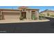 Front view of a tan stucco house with a two-car garage and desert landscaping at 6318 N 19Th St, Phoenix, AZ 85016