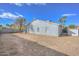 View of the house from the backyard, showing a large yard and block wall at 6339 W Ironwood W Dr, Glendale, AZ 85302