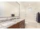 Double vanity bathroom with granite countertops and a soaking tub at 653 N Abalone Dr, Gilbert, AZ 85233