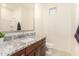 Bathroom with granite countertop, single sink, and shower/tub combo at 653 N Abalone Dr, Gilbert, AZ 85233