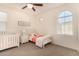 Charming bedroom with crib and twin bed, featuring a large window at 653 N Abalone Dr, Gilbert, AZ 85233