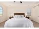 Well-lit bedroom featuring a wooden bed frame and nightstands at 653 N Abalone Dr, Gilbert, AZ 85233