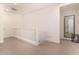 Upstairs hallway with white railing and neutral carpet at 653 N Abalone Dr, Gilbert, AZ 85233