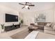 Living room with sectional sofa and large TV at 653 N Abalone Dr, Gilbert, AZ 85233