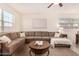 Living room with L-shaped sectional and coffee table at 653 N Abalone Dr, Gilbert, AZ 85233