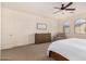 Main bedroom with dresser, seating, and arched windows at 653 N Abalone Dr, Gilbert, AZ 85233