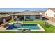 Aerial view of a home's backyard featuring a refreshing pool and a well-manicured lawn at 6551 N 127Th Dr, Glendale, AZ 85307