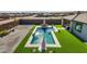 Aerial view showcasing a backyard pool, patio furniture, and surrounding landscape at 6551 N 127Th Dr, Glendale, AZ 85307