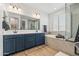 Elegant bathroom with double vanity, soaking tub, and walk-in shower at 6551 N 127Th Dr, Glendale, AZ 85307