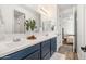 Modern bathroom with double vanity, blue cabinets, and a shower at 6551 N 127Th Dr, Glendale, AZ 85307