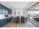 Kitchen breakfast nook with navy cabinets and wood table at 6551 N 127Th Dr, Glendale, AZ 85307