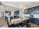 Open dining area with wood table and navy cabinetry at 6551 N 127Th Dr, Glendale, AZ 85307