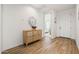 Bright entryway with wood-look tile floors and a stylish console table at 6551 N 127Th Dr, Glendale, AZ 85307