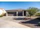 Curb appeal with a two-car garage and well-maintained landscaping at 6551 N 127Th Dr, Glendale, AZ 85307