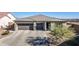 Two-car garage, neutral color palette, and attractive landscaping at 6551 N 127Th Dr, Glendale, AZ 85307