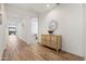 Bright hallway with wood-look tile floors and decorative console at 6551 N 127Th Dr, Glendale, AZ 85307