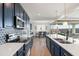 Modern kitchen with navy cabinets, quartz countertops, and stainless steel appliances at 6551 N 127Th Dr, Glendale, AZ 85307