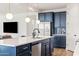 Open concept kitchen island with white quartz countertops and blue cabinetry at 6551 N 127Th Dr, Glendale, AZ 85307