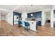 Kitchen boasts an island with seating, blue cabinetry, and white countertops at 6551 N 127Th Dr, Glendale, AZ 85307