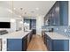 Modern kitchen with white quartz countertops and blue shaker cabinets at 6551 N 127Th Dr, Glendale, AZ 85307