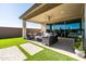 Relaxing covered patio, artificial turf, and walkway at 6551 N 127Th Dr, Glendale, AZ 85307