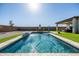 Stunning pool with a water feature, surrounded by artificial turf and a patio at 6551 N 127Th Dr, Glendale, AZ 85307