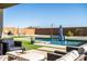 Inviting pool with waterfall feature and patio furniture at 6551 N 127Th Dr, Glendale, AZ 85307