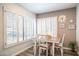 Charming dining area with white table and chairs, near a window at 7710 W Aster Dr, Peoria, AZ 85381