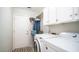 Bright laundry room with washer, dryer, and storage cabinets at 7710 W Aster Dr, Peoria, AZ 85381