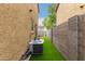 Small grassy backyard with block wall and AC unit at 7844 W Bonitos Dr, Phoenix, AZ 85035