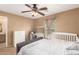 Bright bedroom with a comfortable bed, dresser, and ceiling fan at 7844 W Bonitos Dr, Phoenix, AZ 85035