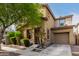 Tan two-story house with a tree in front at 7844 W Bonitos Dr, Phoenix, AZ 85035