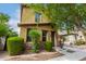 Tan two-story house with a tree in front at 7844 W Bonitos Dr, Phoenix, AZ 85035