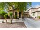 Tan two-story house with a tree in front at 7844 W Bonitos Dr, Phoenix, AZ 85035