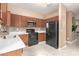 Well-equipped kitchen featuring wood cabinets and black appliances at 7844 W Bonitos Dr, Phoenix, AZ 85035